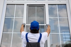 Maryland window installer contractor holding white windows