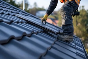 Maryland roof replacement worker replacing tiles on a slanted roof