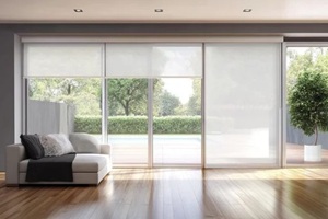 modern living room with large sliding glass doors and sheer roller shades